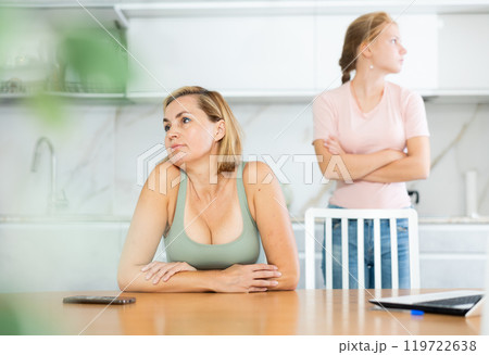 Quarreled mum and daughter do not talk ignore to each other and look in different directions. 119722638