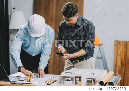 Team Engineers with draft plan of building on constructing site. Engineer work on site. engineer visit and inspection site engineer. Inspector engineer check and working on site. Team Engineers with draft plan of building on constructing site. Engineer work on site. engineer visit and inspection site engineer. Inspector engineer check and working on site. 119722926