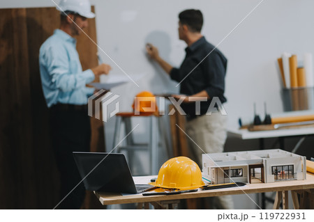 Team Engineers with draft plan of building on constructing site. Engineer work on site. engineer visit and inspection site engineer. Inspector engineer check and working on site. Team Engineers with draft plan of building on constructing site. Engineer work on site. engineer visit and inspection site engineer. Inspector engineer check and working on site. 119722931