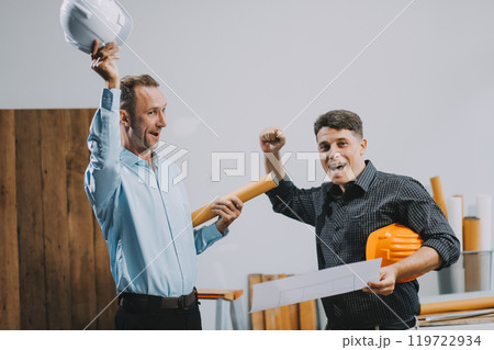 Team Engineers with draft plan of building on constructing site. Engineer work on site. engineer visit and inspection site engineer. Inspector engineer check and working on site. 119722934