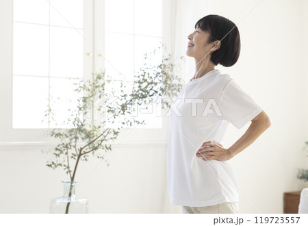 部屋で体操をするミドル女性 119723557