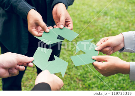 People holding recycle symbol against green spring background. Earth day holiday concept. People holding recycle symbol against green spring background. Earth day holiday concept. 119725319