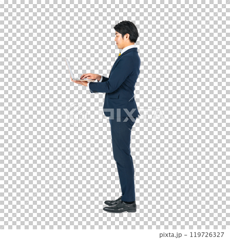 A young male business person using a laptop computer. A transparent full-body photo PNG precisely cut by hand 119726327