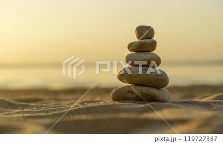 Zen stones background. Pyramid of stones on the background of sunset on the sea beach. Relax, balance, calm, concept. 119727387