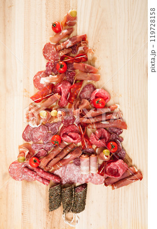 Christmas tree made of sausage on a background of a wooden wall Christmas tree made of sausage on a background of a wooden wall 119728158