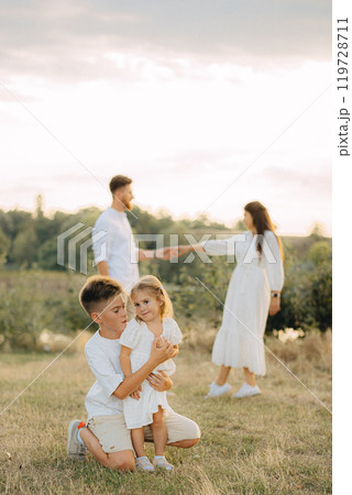 Parents, kids and happy family in park, garden and sunshine field outdoors for bonding, love and quality time together. Mom, dad and girl child of black family having fun, relax and care in nature Parents, kids and happy family in park, garden and sunshine field outdoors for bonding, love and quality time together. Mom, dad and girl child of black family having fun, relax and care in nature 119728711