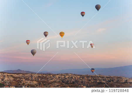 Colorful hot air balloons fly gracefully over a vibrant skyline in valley Cappadocia Turkey 119728848