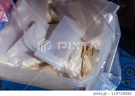 A large plastic container that is filled to the brim with numerous plastic bags 119728886