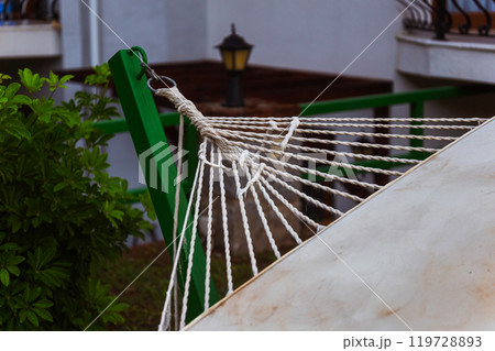 The base of a hammock tied to a pole in the garden 119728893