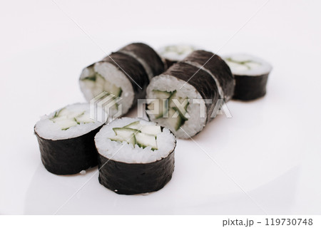 Maki sushi rolls with cucumber and avocado on plate Maki sushi rolls with cucumber and avocado on plate 119730748