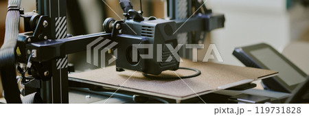Close-up view of 3D printer fabricating an item with precision. The device showcases intricate mechanisms and technological innovation in a modern setting Close-up view of 3D printer fabricating an item with precision. The device showcases intricate mechanisms and technological innovation in a modern setting 119731828