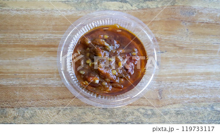 Sambal is Indonesian chili sauce made from peppers, shrimp paste, garlic, ginger, shallot, scallion, palm sugar, and lime juice. Adds spicy, flavorful kick to dishes. Sambal in a small plastic cup. Sambal is Indonesian chili sauce made from peppers, shrimp paste, garlic, ginger, shallot, scallion, palm sugar, and lime juice. Adds spicy, flavorful kick to dishes. Sambal in a small plastic cup. 119733117