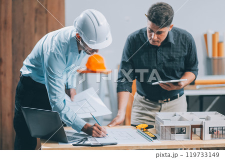 Team Engineers with draft plan of building on constructing site. Engineer work on site. engineer visit and inspection site engineer. Inspector engineer check and working on site. 119733149