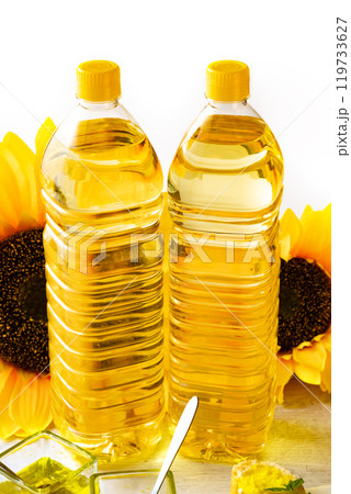 Composition with sunflower oil on white wooden table on white background. Composition with sunflower oil on white wooden table on white background. 119733627