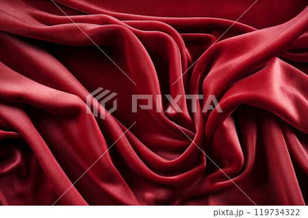 Red luxurious background, the red velvet fabric lies in soft waves. 119734322