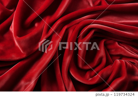 Red luxurious background, the red velvet fabric lies in soft waves. 119734324