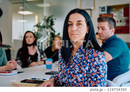 Diverse Business Team Discussing Projects in a Modern Glass Office. Diverse Business Team Discussing Projects in a Modern Glass Office. 119734393