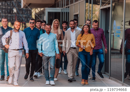 A diverse group of businessmen and colleagues walking together by their workplace, showcasing collaboration and teamwork in the company. A diverse group of businessmen and colleagues walking together by their workplace, showcasing collaboration and teamwork in the company. 119734668