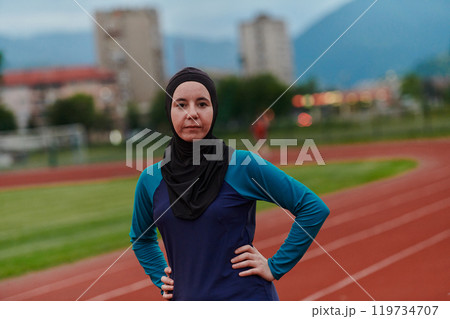 A Muslim woman with a burqa, an Islamic sportswoman resting after a vigorous training session on the marathon course. A hijab woman is preparing for a marathon competition 119734707