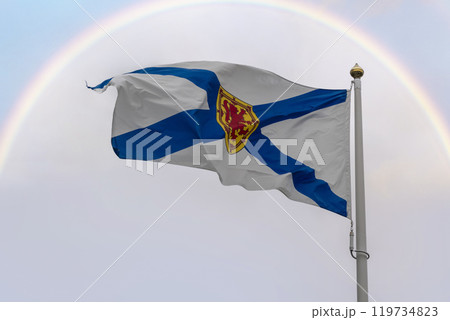 Flag of Nova Scotia framed by arc of rainbow 119734823