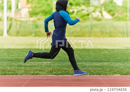 A muslim woman in a burqa sports muslim clothes running on a marathon course and preparing for upcoming competitions A muslim woman in a burqa sports muslim clothes running on a marathon course and preparing for upcoming competitions 119734830