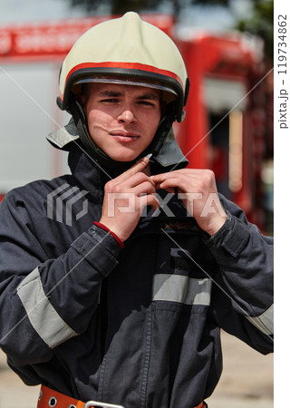 Firefighter Stands Proudly with Professional Gear Beside Fire Truck After Intense Training Firefighter Stands Proudly with Professional Gear Beside Fire Truck After Intense Training 119734862