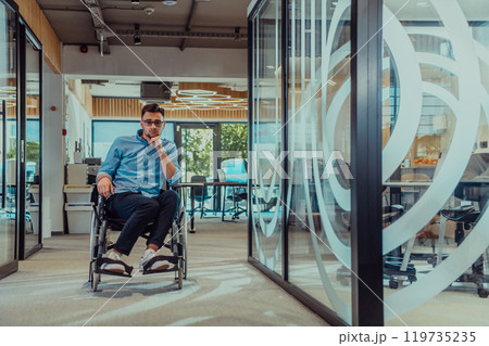 In a large modern corporation, a determined businessman in a wheelchair navigates through a hallway, embodying empowerment and inclusivity in the corporate world. 119735235