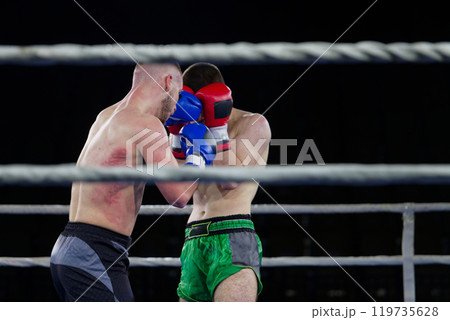 Fierce boxing match showcases athletes' power and skill. 119735628