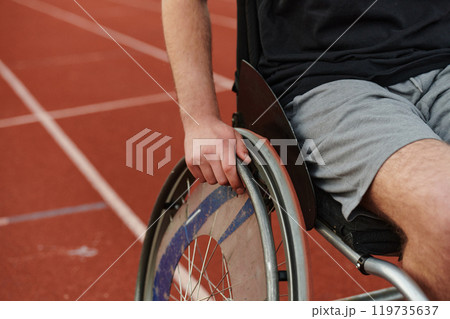 Close up photo of a person with disability in a wheelchair training tirelessly on the track in preparation for the Paralympic Games Close up photo of a person with disability in a wheelchair training tirelessly on the track in preparation for the Paralympic Games 119735637