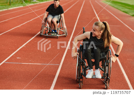 An inspiring couple with disability showcase their incredible determination and strength as they train together for the Paralympics pushing their wheelchairs in marathon track  119735707