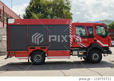 A state-of-the-art firetruck, equipped with advanced rescue technology, stands ready with its skilled firefighting team, prepared to intervene and respond rapidly to emergencies, ensuring the safety A state-of-the-art firetruck, equipped with advanced rescue technology, stands ready with its skilled firefighting team, prepared to intervene and respond rapidly to emergencies, ensuring the safety 119735711