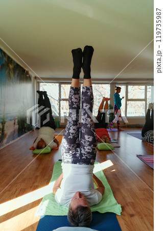 Senior Women Embrace Wellness: Yoga and Stretching in a Sunlit Space Senior Women Embrace Wellness: Yoga and Stretching in a Sunlit Space 119735987