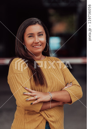 A powerful portrait of a businesswoman, standing confidently with her arms crossed, representing the determination of the female gender and embodying strength and success 119736056