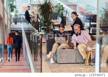 In a modern startup office, a diverse group of young professionals collaboratively tackles various business problems and challenges, surrounded by their engaged colleagues, fostering innovation and In a modern startup office, a diverse group of young professionals collaboratively tackles various business problems and challenges, surrounded by their engaged colleagues, fostering innovation and 119736471
