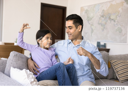 Caring Indian dad teaching kid to fight, giving fist bump 119737136