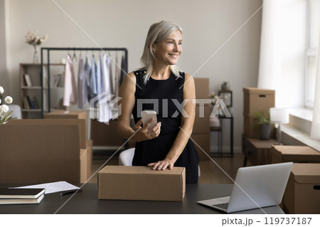 Old woman prepare electronic waybill for parcel in mobile app Old woman prepare electronic waybill for parcel in mobile app 119737187