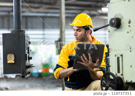 Industrial man engineer wear uniform and helmet using laptop are checking system machine at factory. manager technician manufacturing. Workers industrial factory. Industrial man engineer wear uniform and helmet using laptop are checking system machine at factory. manager technician manufacturing. Workers industrial factory. 119737351