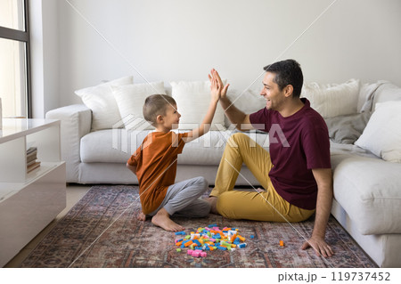 Cheerful father and cute son child clapping hands Cheerful father and cute son child clapping hands 119737452