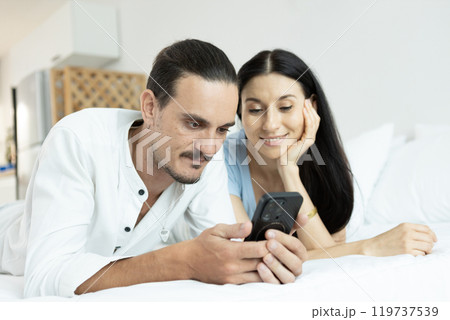 happy man woman couple romantic lying together lover on bed. happy man woman couple romantic lying together lover on bed. 119737539