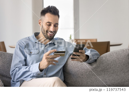 Happy satisfied Latin bank customer man shopping online 119737543