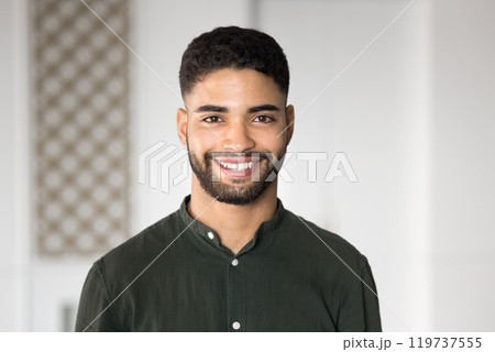 Happy handsome young Arabic businessman posing for head shot Happy handsome young Arabic businessman posing for head shot 119737555