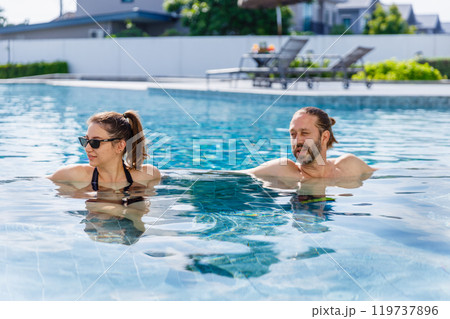 Happy vacation kid boy with family parent have fun enjoy at swimming pool. father and mother with son cheerful activity relaxing in summer holiday. Happy vacation kid boy with family parent have fun enjoy at swimming pool. father and mother with son cheerful activity relaxing in summer holiday. 119737896