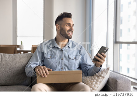 Positive dreamy customer man using mobile phone, ordering delivery service 119737916