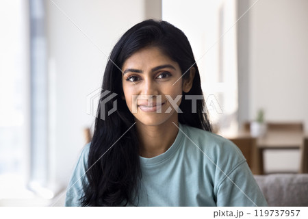 Positive beautiful relaxed Indian girl home head shot 119737957
