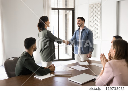 Happy diverse business colleagues shaking hands at office meeting 119738083
