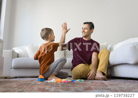 Happy proud dad and son kid making successful high five Happy proud dad and son kid making successful high five 119738227