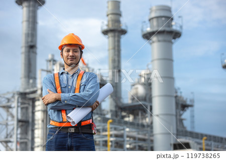 Portrait of asian worker power plant factory holding blueprint arms crossed. Engineer wearing safety uniform helmet. man electrical generator repair operations. Worker petrochemical energy. 119738265