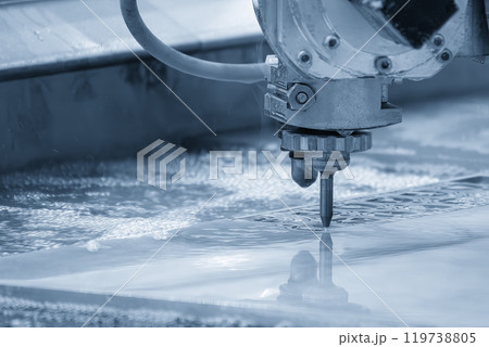 Close-up scene of multi-axis abrasive waterjet cutting machine cutting the aluminum plate. Close-up scene of multi-axis abrasive waterjet cutting machine cutting the aluminum plate. 119738805