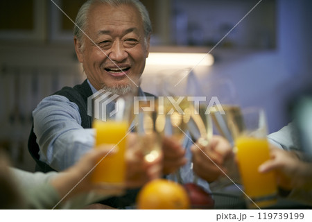 elderly asian man having a toast at dinner 119739199