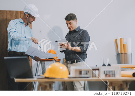 Team Engineers with draft plan of building on constructing site. Engineer work on site. engineer visit and inspection site engineer. Inspector engineer check and working on site. 119739271